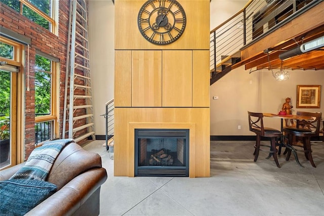 319 Atlanta St SE Unit 315, Marietta, GA 30060 - living room with a high ceiling, concrete floors, baseboards, and a glass covered fireplace