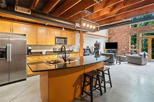 319 Atlanta St SE Unit 315, Marietta, GA 30060 - kitchen featuring stainless steel appliances, concrete floors, dark countertops, a sink, and brick wall