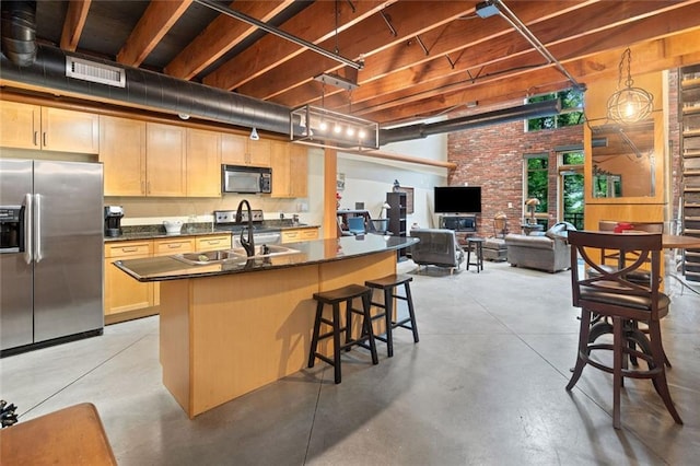 319 Atlanta St SE Unit 315, Marietta, GA 30060 - kitchen featuring stainless steel fridge, black microwave, finished concrete floors, a sink, and dark countertops
