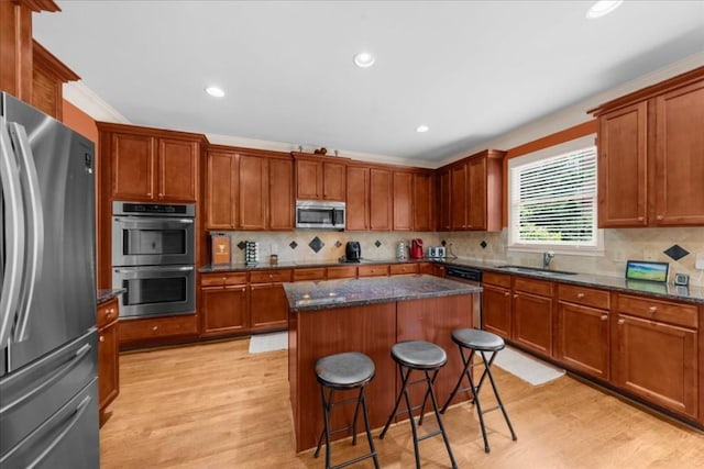 3086 Frazier Walk, Decatur, GA 30033 - kitchen featuring stainless steel appliances, light wood-style floors, a kitchen breakfast bar, a kitchen island, and a sink