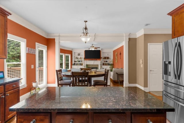 3086 Frazier Walk, Decatur, GA 30033 - kitchen with stainless steel fridge, a ceiling fan, baseboards, dark stone countertops, and a fireplace