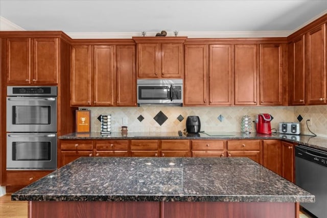3086 Frazier Walk, Decatur, GA 30033 - kitchen featuring stainless steel appliances, tasteful backsplash, dark stone countertops, a center island, and crown molding
