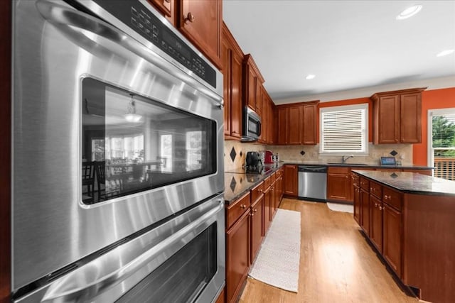 3086 Frazier Walk, Decatur, GA 30033 - kitchen featuring appliances with stainless steel finishes, light wood-style floors, backsplash, dark stone countertops, and recessed lighting
