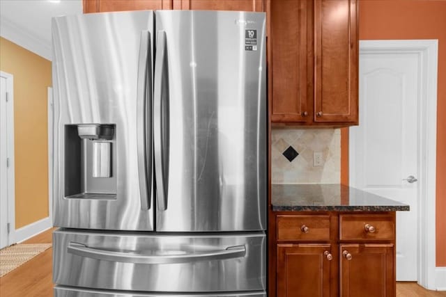 3086 Frazier Walk, Decatur, GA 30033 - kitchen featuring stainless steel refrigerator with ice dispenser, dark stone countertops, light wood-type flooring, backsplash, and baseboards