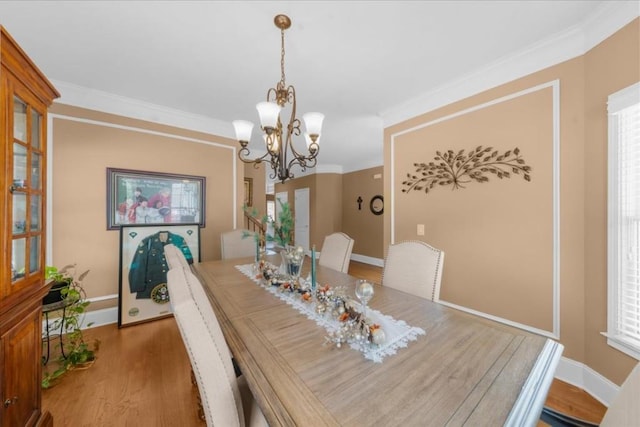 3086 Frazier Walk, Decatur, GA 30033 - dining area with light wood finished floors, a chandelier, crown molding, and baseboards
