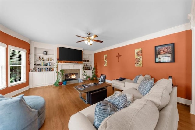 3086 Frazier Walk, Decatur, GA 30033 - living area featuring ceiling fan, a warm lit fireplace, baseboards, wood finished floors, and crown molding