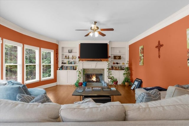 3086 Frazier Walk, Decatur, GA 30033 - living area featuring ceiling fan, wood finished floors, a warm lit fireplace, built in shelves, and crown molding