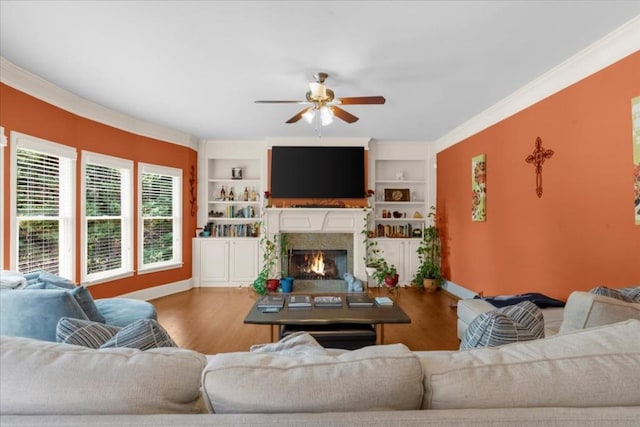 3086 Frazier Walk, Decatur, GA 30033 - living area featuring ceiling fan, wood finished floors, a lit fireplace, built in shelves, and crown molding