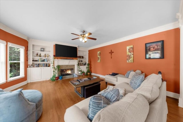 3086 Frazier Walk, Decatur, GA 30033 - living room with a lit fireplace, ceiling fan, baseboards, wood finished floors, and built in shelves