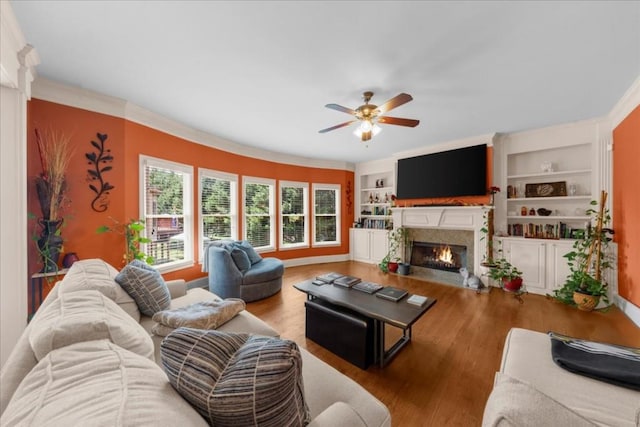 3086 Frazier Walk, Decatur, GA 30033 - living area featuring ceiling fan, a fireplace with flush hearth, wood finished floors, crown molding, and built in shelves