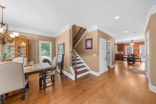 3086 Frazier Walk, Decatur, GA 30033 - dining area featuring stairs, baseboards, a chandelier, crown molding, and light wood-type flooring