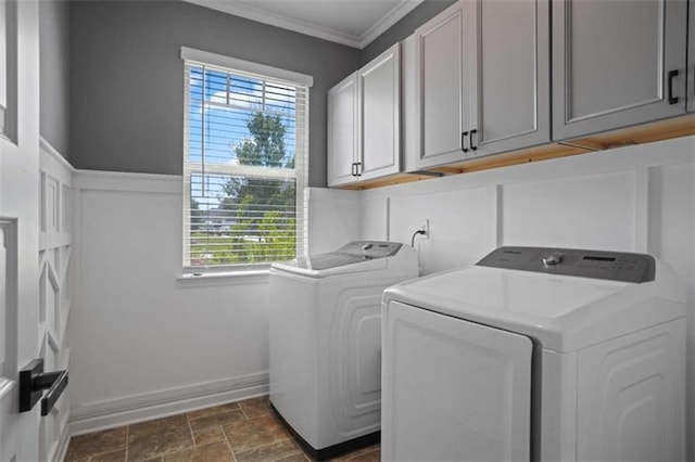 laundry area with cabinets, ornamental molding, a healthy amount of sunlight, and washing machine and dryer