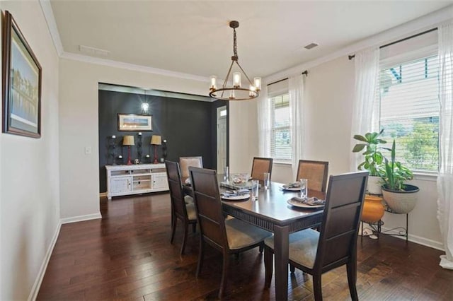 dining space featuring an inviting chandelier, ornamental molding, and dark wood-type flooring