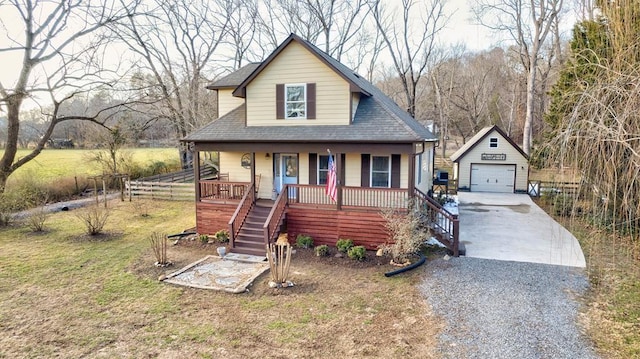 bungalow featuring a garage, an outdoor structure, a porch, and a front yard