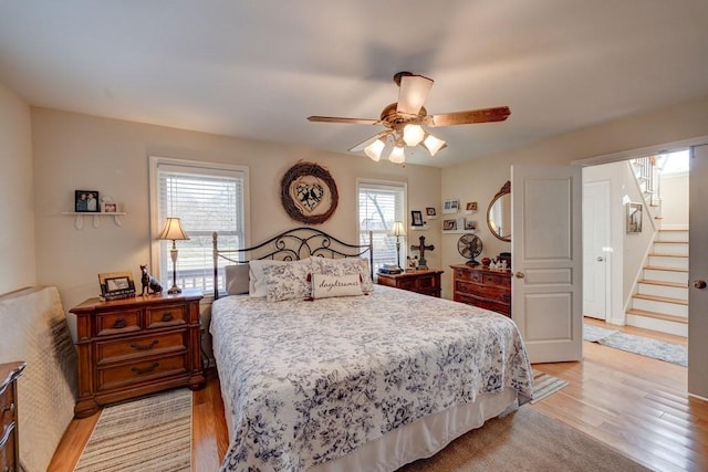 bedroom with ceiling fan and light hardwood / wood-style flooring