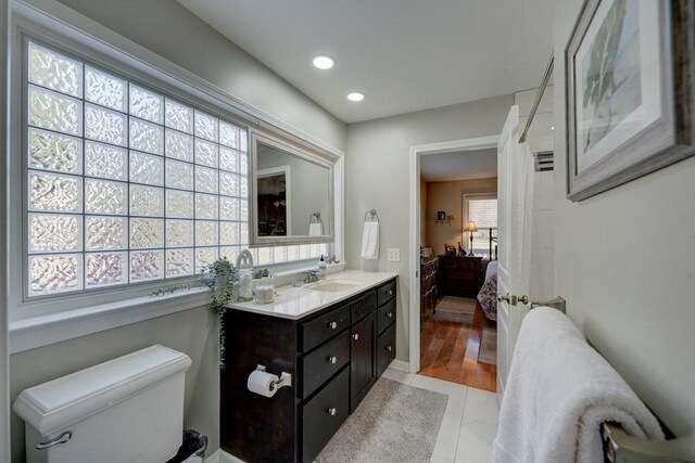 bathroom with vanity, tile patterned floors, and toilet