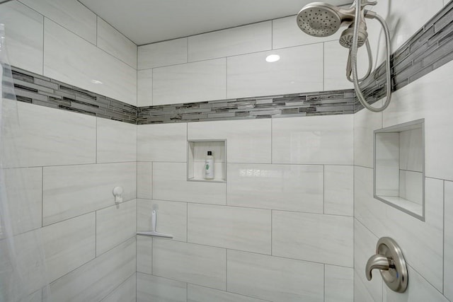 bathroom with tiled shower