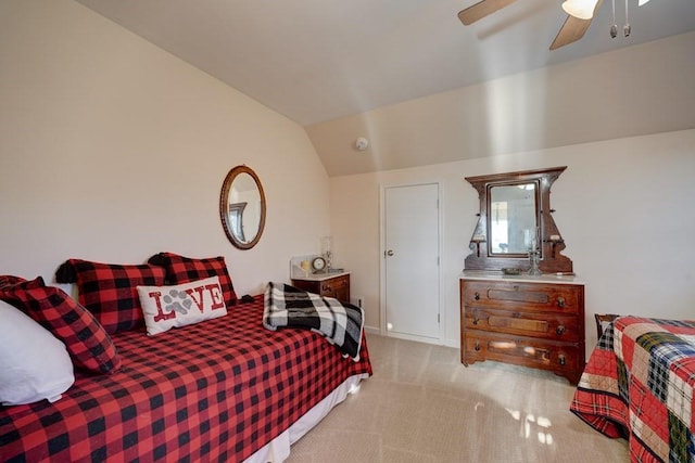 bedroom featuring lofted ceiling, light colored carpet, and ceiling fan