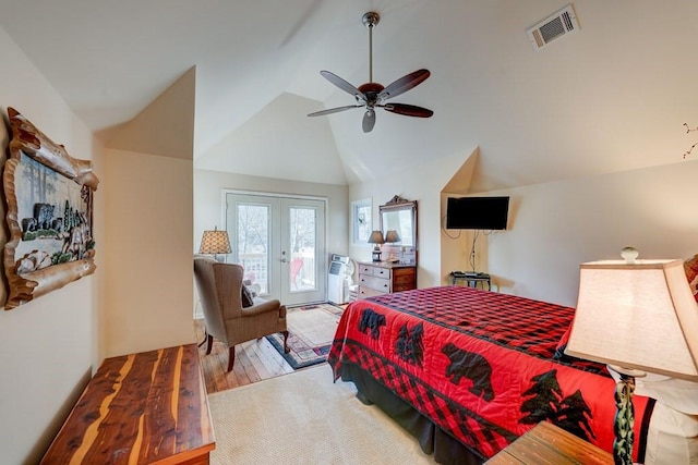 bedroom featuring lofted ceiling, access to exterior, ceiling fan, light wood-type flooring, and french doors