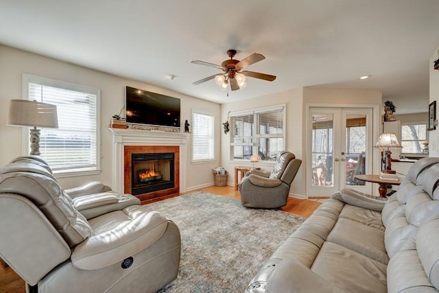 living room featuring hardwood / wood-style flooring, ceiling fan, and french doors