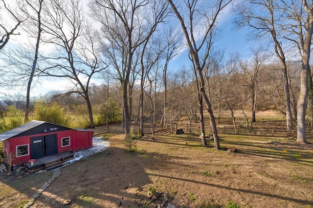 view of yard featuring a storage unit and a rural view