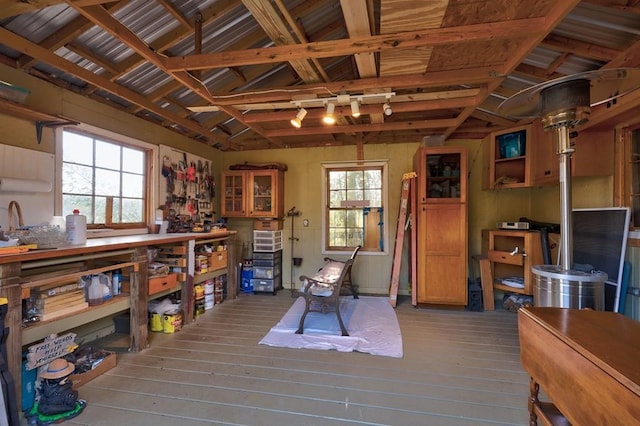 misc room with vaulted ceiling, hardwood / wood-style floors, and a workshop area