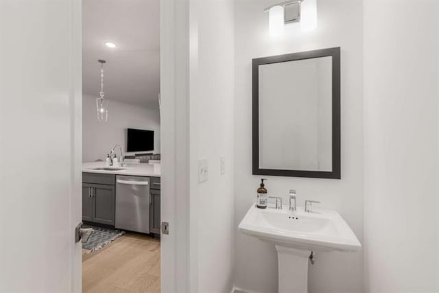 bathroom with a sink and wood finished floors