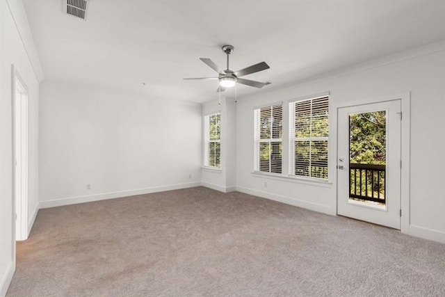 empty room with ceiling fan, light colored carpet, and visible vents