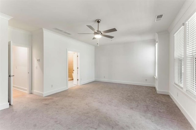 unfurnished bedroom with crown molding, light carpet, and visible vents