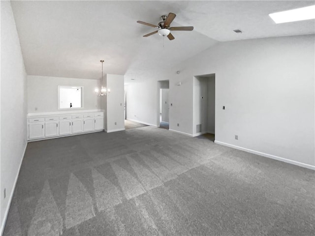 unfurnished living room featuring ceiling fan with notable chandelier, dark colored carpet, baseboards, and lofted ceiling