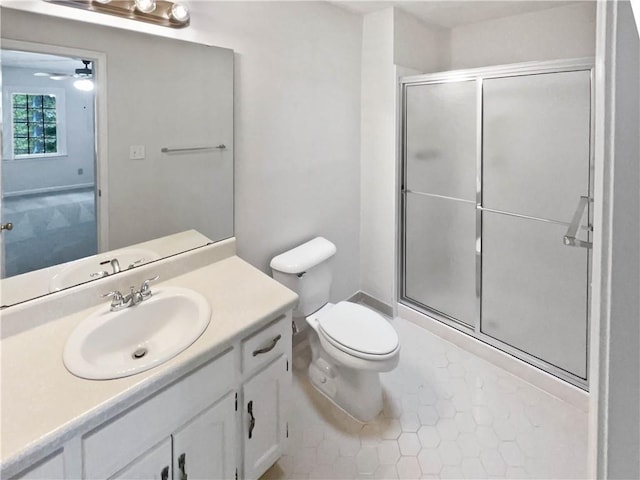 full bathroom with toilet, a shower stall, vanity, and a ceiling fan