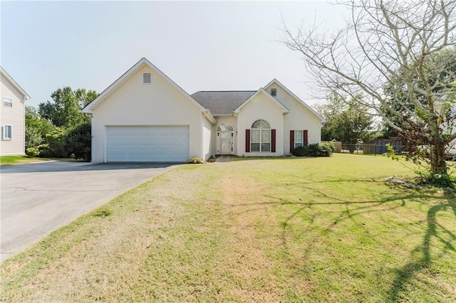 view of front of home with a front lawn and a garage