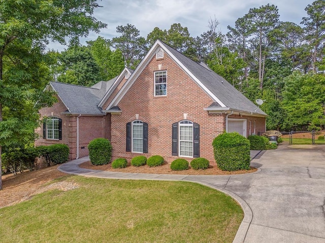 27 Bluff Mountain Dr SW, Rome, GA 30165 - view of front facade with brick siding, a front yard, driveway, an attached garage, and roof with shingles