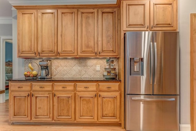 27 Bluff Mountain Dr SW, Rome, GA 30165 - kitchen with stainless steel refrigerator with ice dispenser, backsplash, dark stone counters, and brown cabinetry