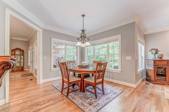 27 Bluff Mountain Dr SW, Rome, GA 30165 - dining area featuring light wood-type flooring, a chandelier, baseboards, and ornamental molding