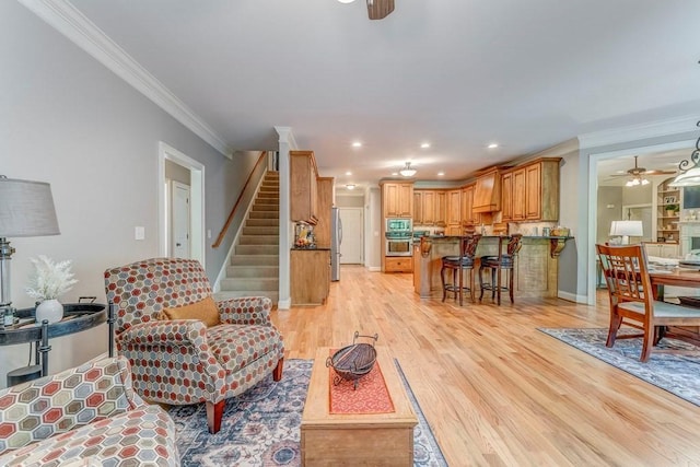 27 Bluff Mountain Dr SW, Rome, GA 30165 - living area with a ceiling fan, ornamental molding, light wood-style floors, stairway, and recessed lighting