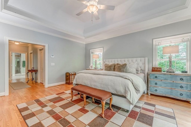 27 Bluff Mountain Dr SW, Rome, GA 30165 - bedroom featuring a tray ceiling, light wood-type flooring, ornamental molding, baseboards, and a ceiling fan