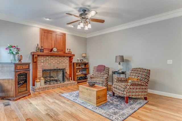 27 Bluff Mountain Dr SW, Rome, GA 30165 - living area with ceiling fan, ornamental molding, light wood-style flooring, baseboards, and a brick fireplace