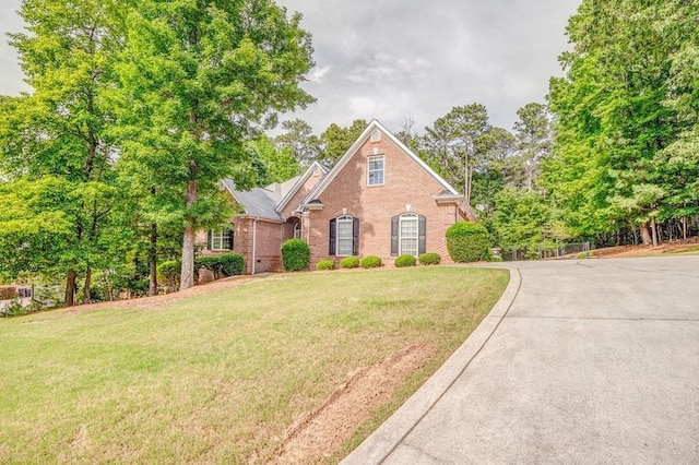 27 Bluff Mountain Dr SW, Rome, GA 30165 - view of front facade featuring brick siding, a front yard, and concrete driveway