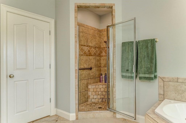 27 Bluff Mountain Dr SW, Rome, GA 30165 - bathroom with a stall shower, a garden tub, baseboards, and tile patterned flooring