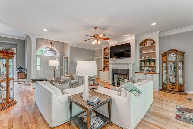 27 Bluff Mountain Dr SW, Rome, GA 30165 - living room featuring light wood finished floors, ornamental molding, a ceiling fan, baseboards, and a premium fireplace