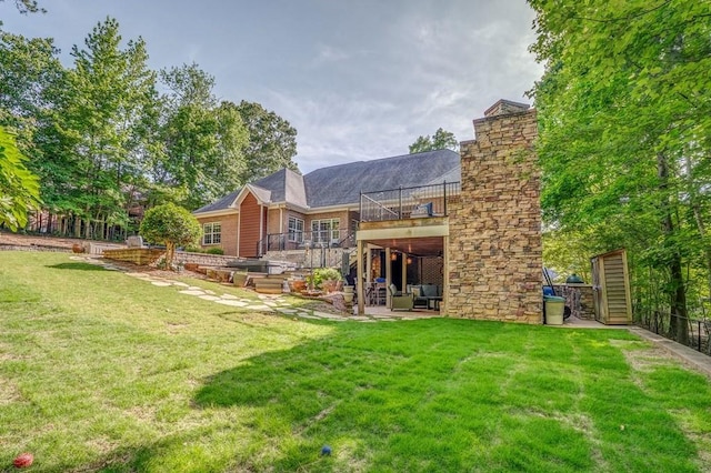 27 Bluff Mountain Dr SW, Rome, GA 30165 - back of property featuring a patio, a yard, a balcony, a chimney, and brick siding