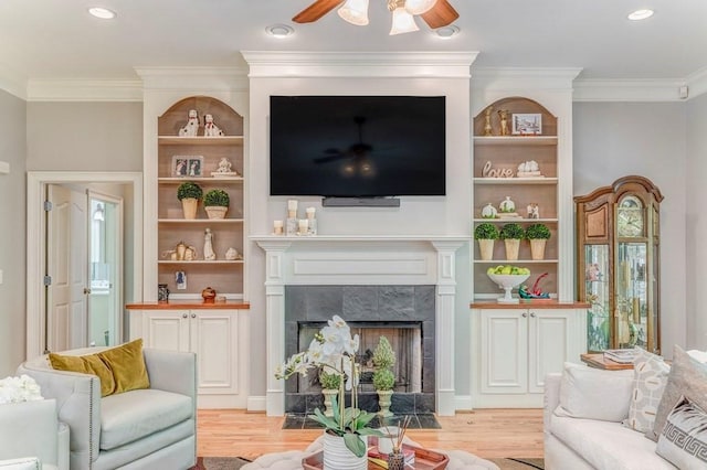 27 Bluff Mountain Dr SW, Rome, GA 30165 - living area featuring light wood-type flooring, a ceiling fan, a tile fireplace, ornamental molding, and recessed lighting