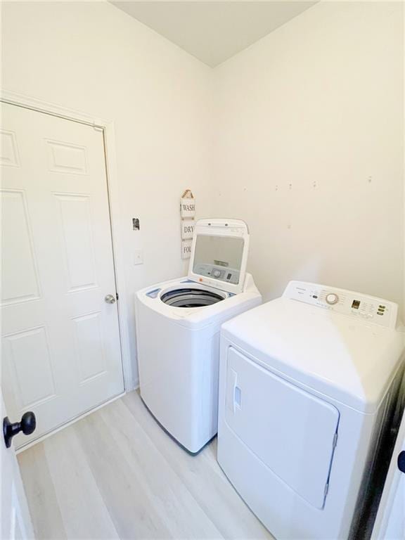 3130 Haynes Park Dr, Lithonia, GA 30038 - laundry room with washing machine and dryer and light wood finished floors