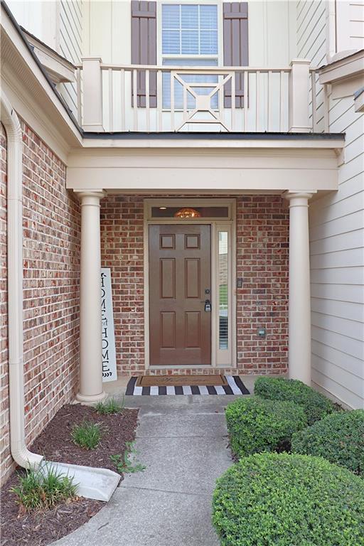 3130 Haynes Park Dr, Lithonia, GA 30038 - property entrance featuring a balcony and brick siding