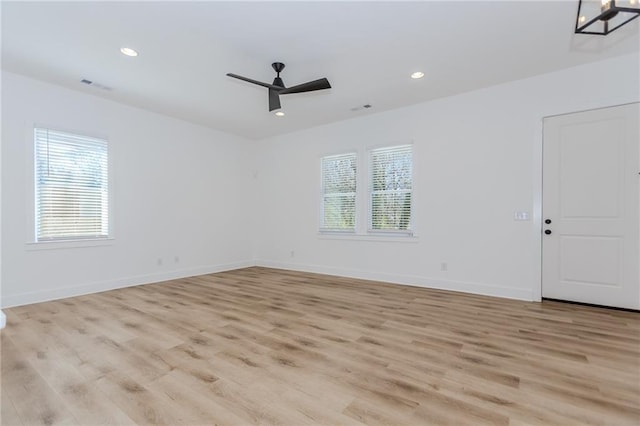 unfurnished room featuring plenty of natural light, visible vents, baseboards, and recessed lighting