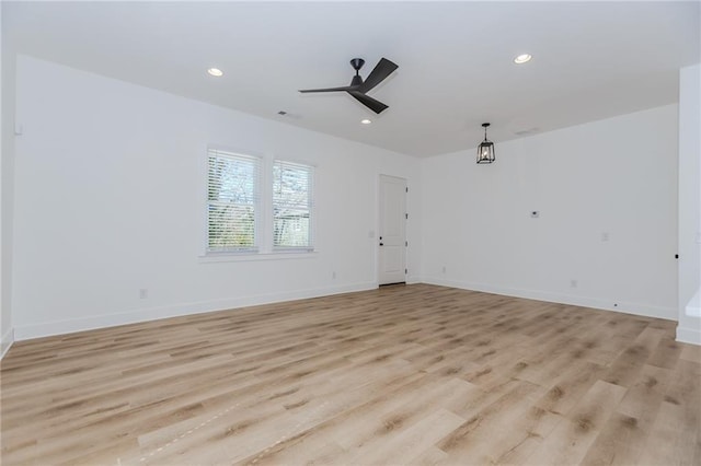 empty room featuring light wood finished floors, baseboards, a ceiling fan, and recessed lighting