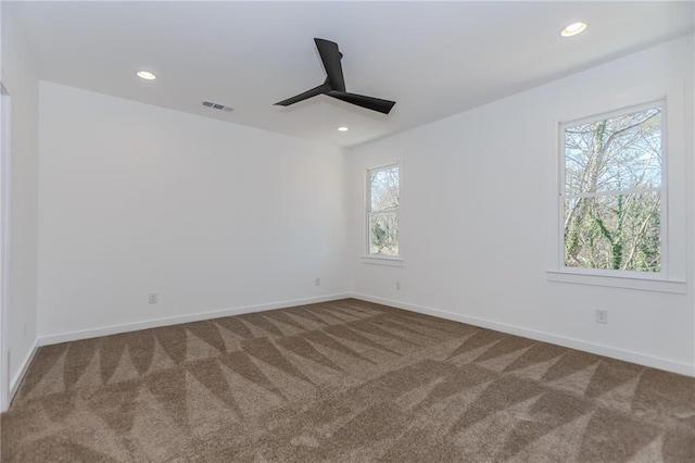 empty room featuring recessed lighting, carpet flooring, visible vents, and baseboards