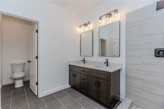 bathroom with double vanity, tile patterned flooring, and a sink