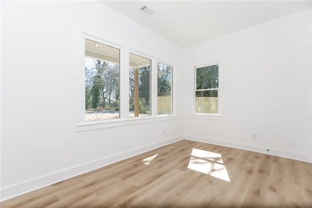 empty room featuring light wood-style floors and baseboards